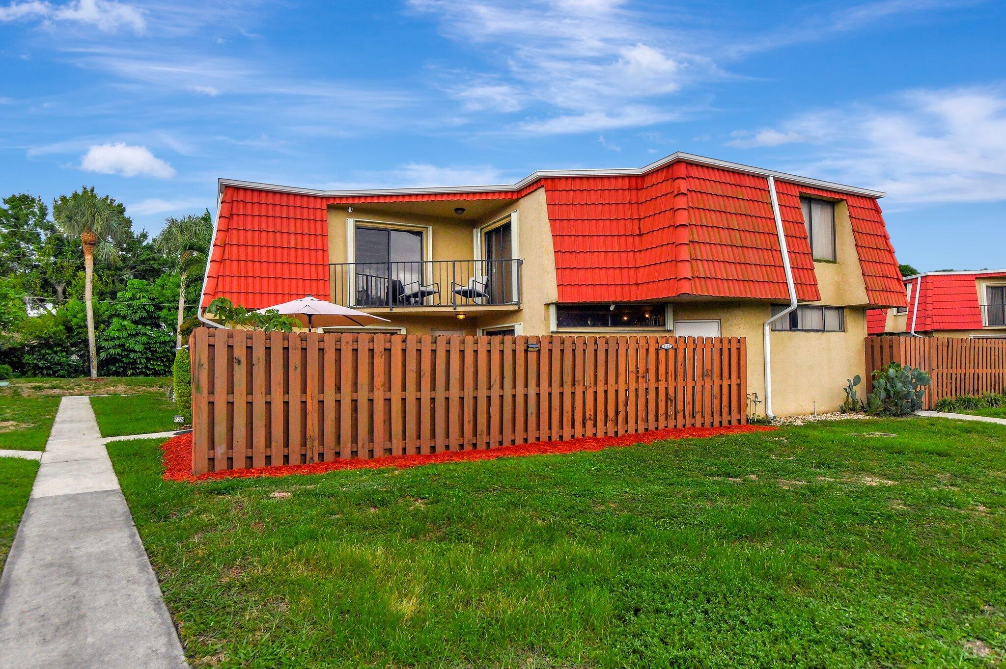 a view of a house with backyard and porch