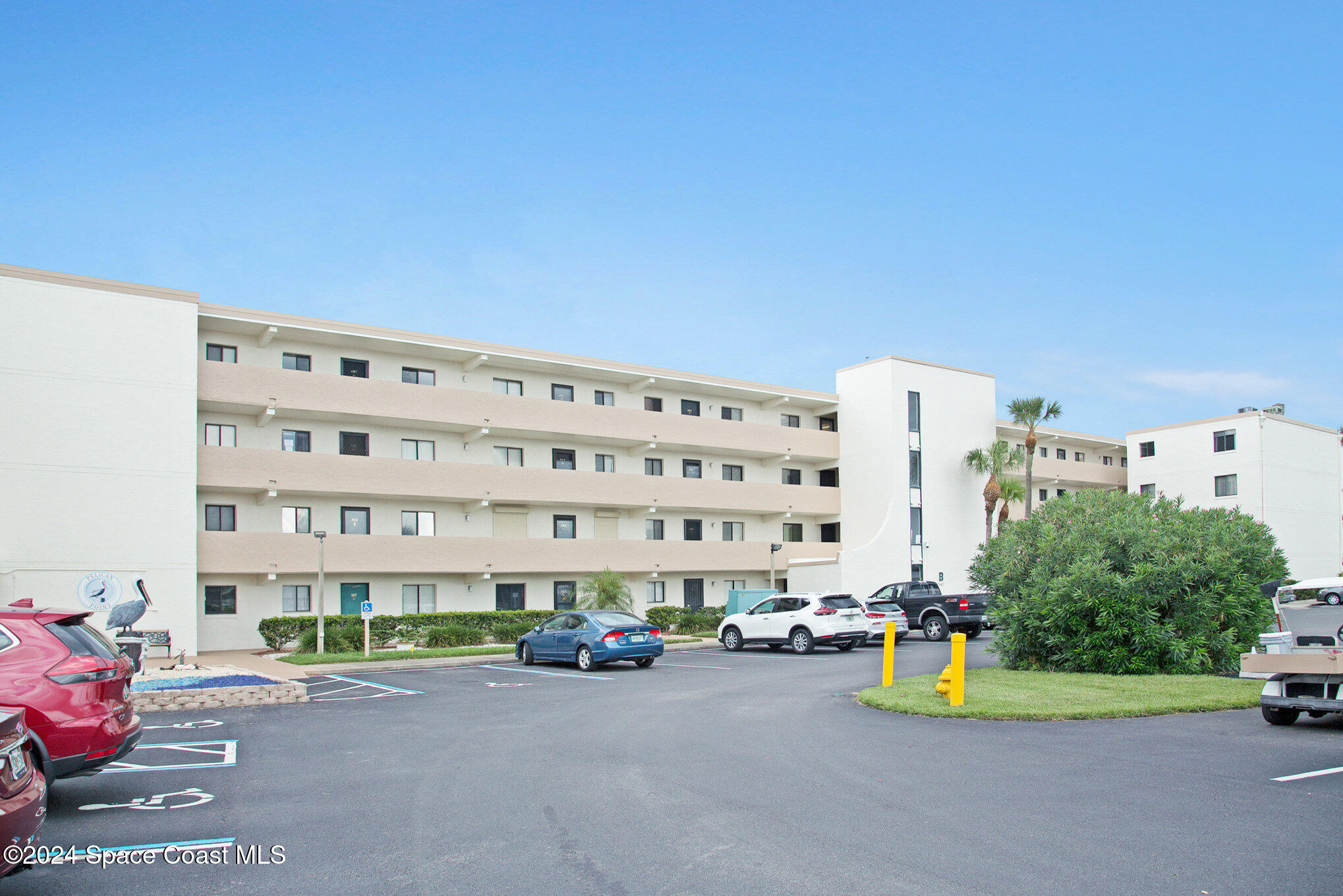 a view of a building with backyard space and parking