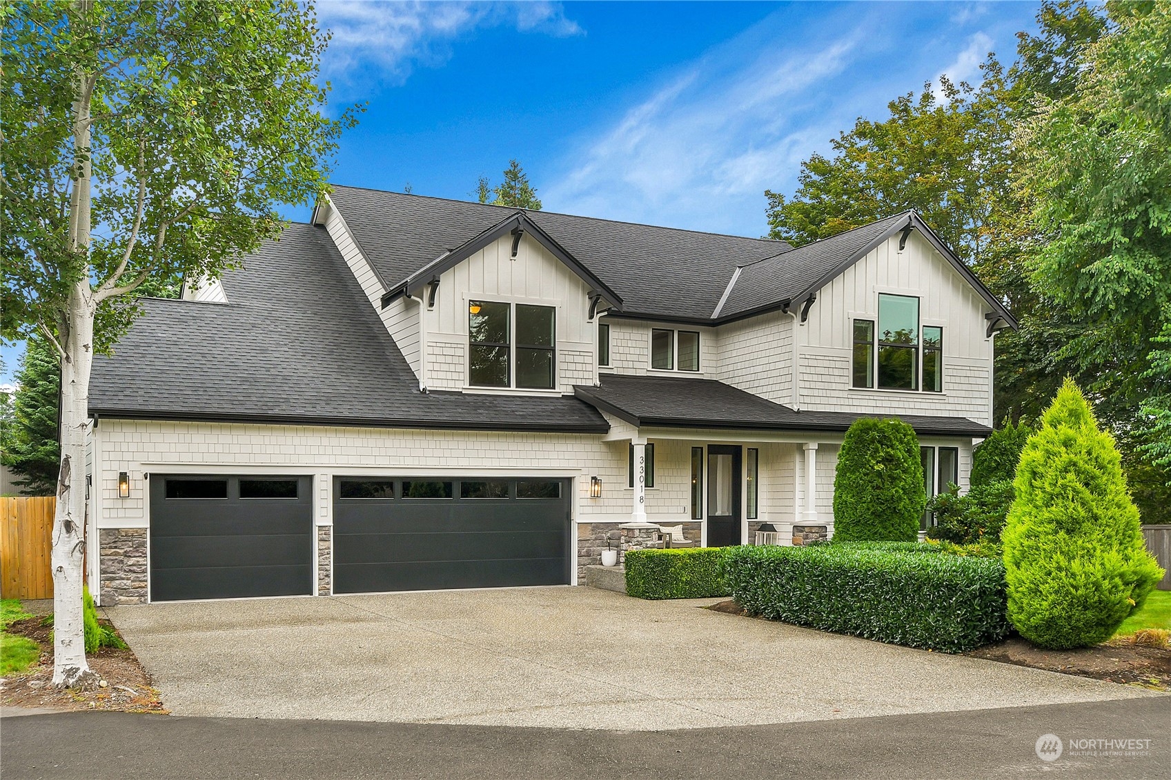 a front view of a house with a garden