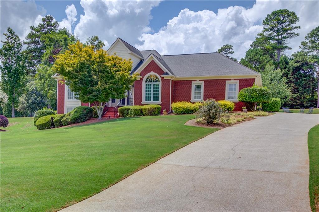 a front view of house with yard and green space