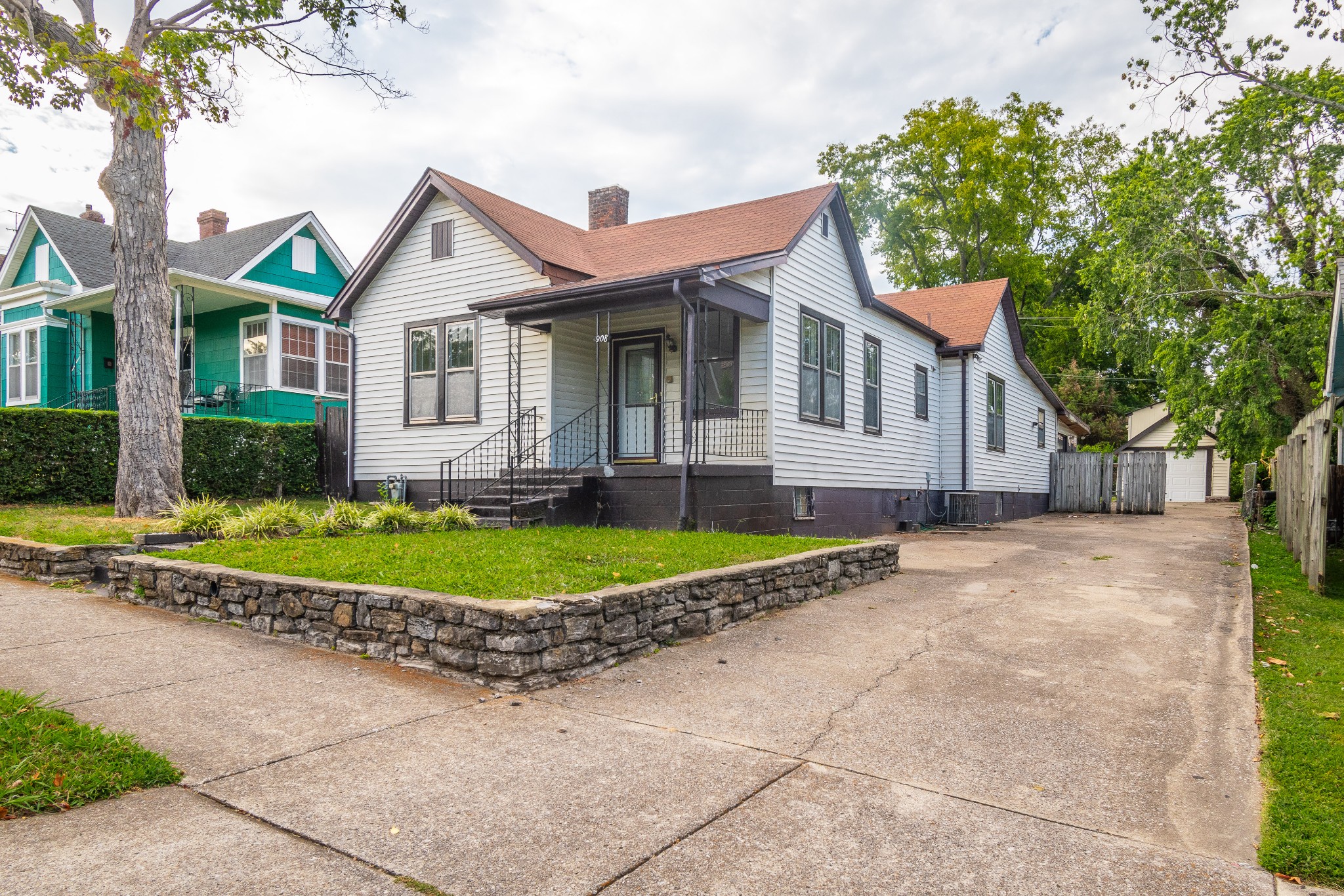 a front view of a house with a yard and potted plants