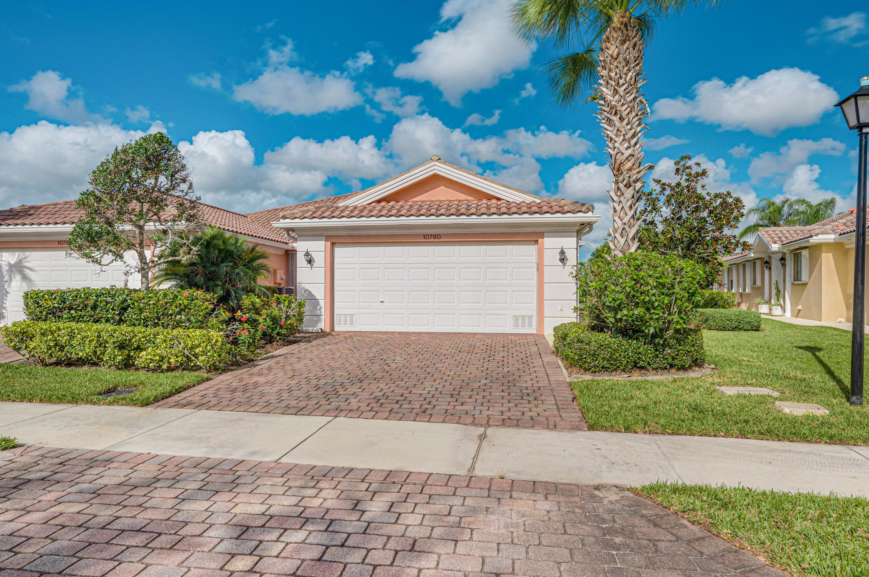 a front view of a house with a yard and a garage