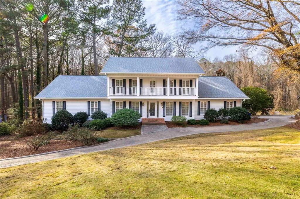 a front view of a house with swimming pool and porch