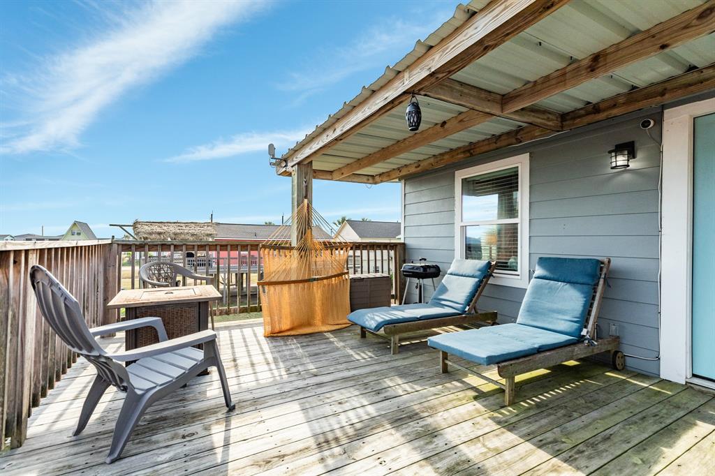 a roof deck with a table and chairs