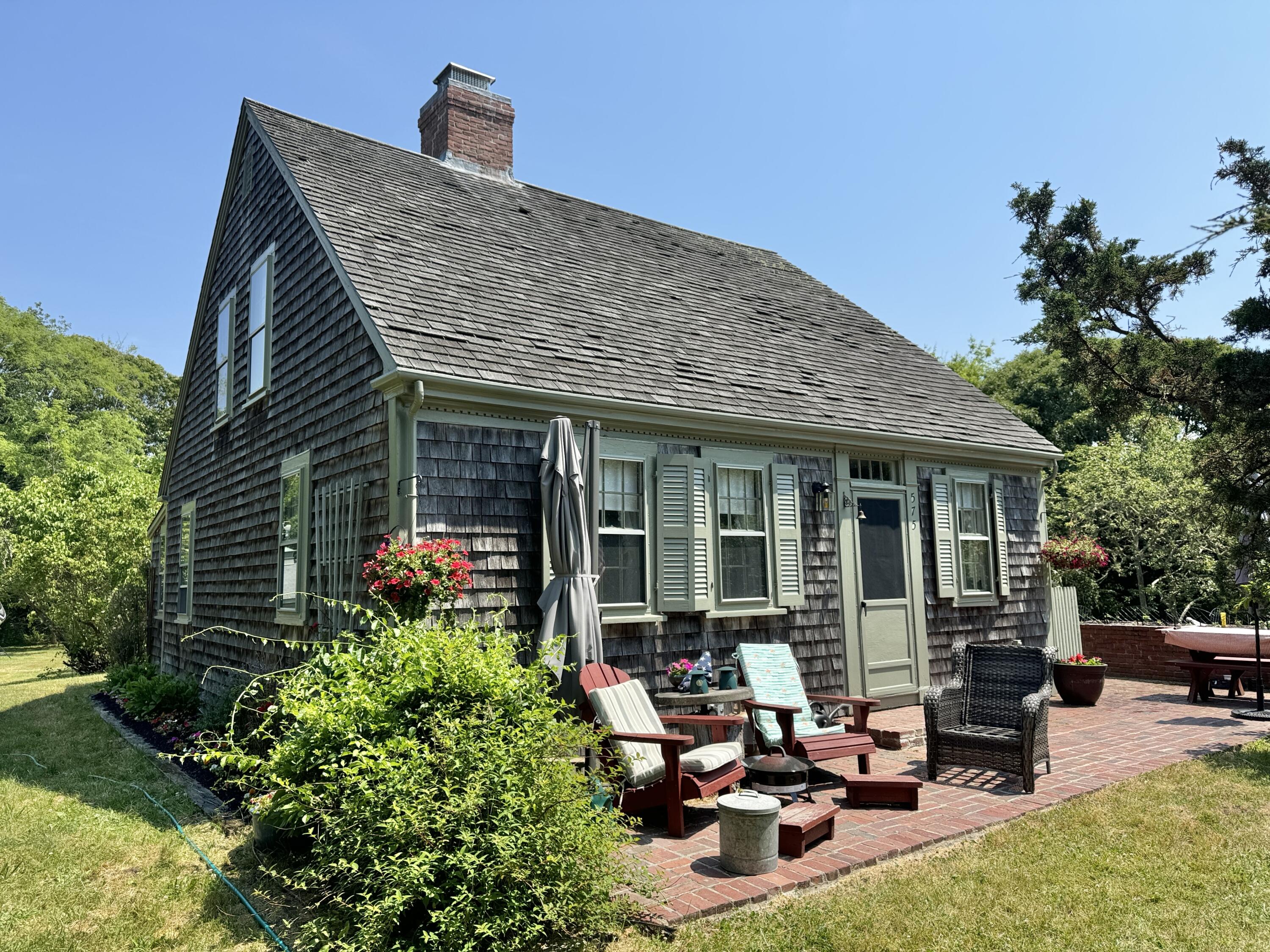 a view of a house with sitting area and garden