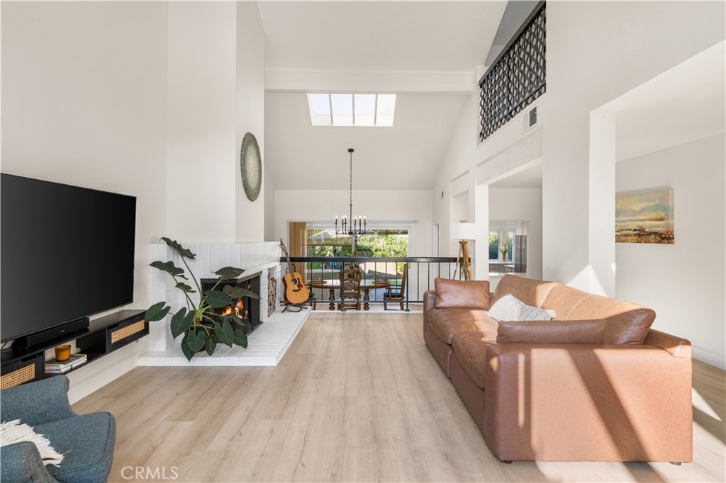 a living room with furniture a flat screen tv and a large window