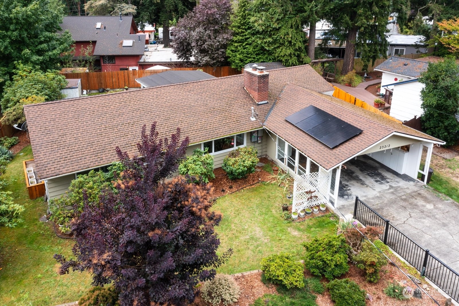 an aerial view of a house with swimming pool and big yard