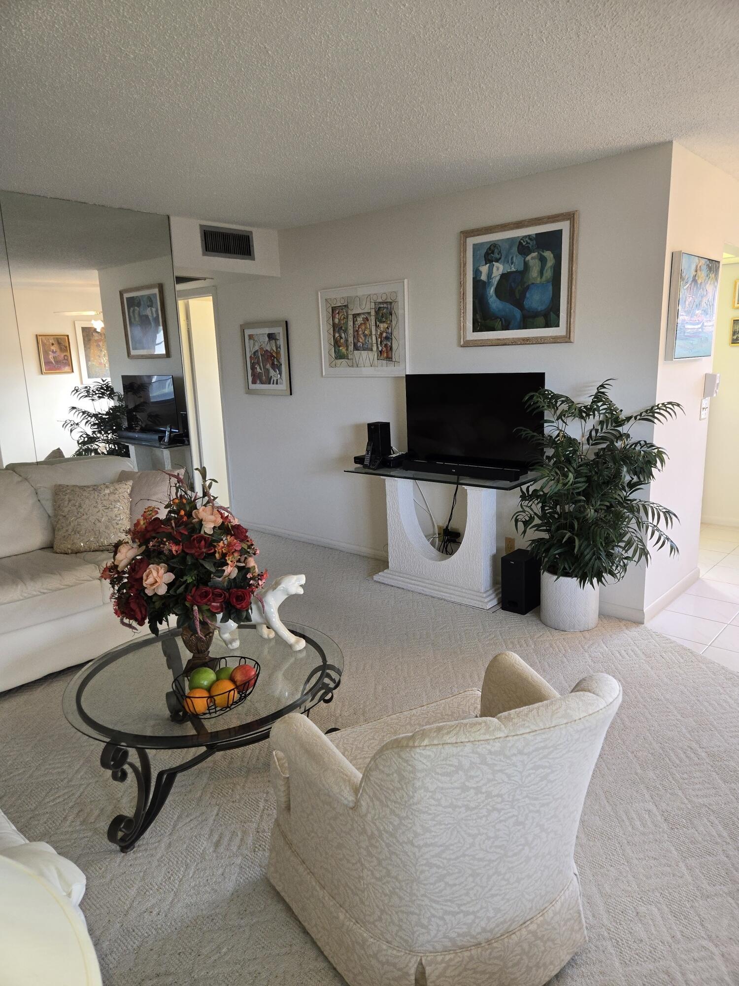 a living room with furniture and a potted plant