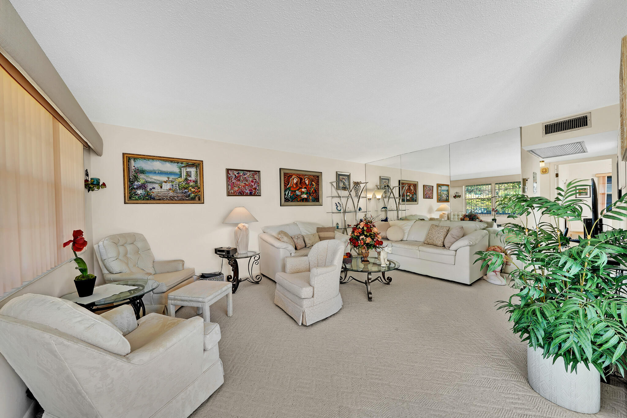 a living room with furniture and a potted plant