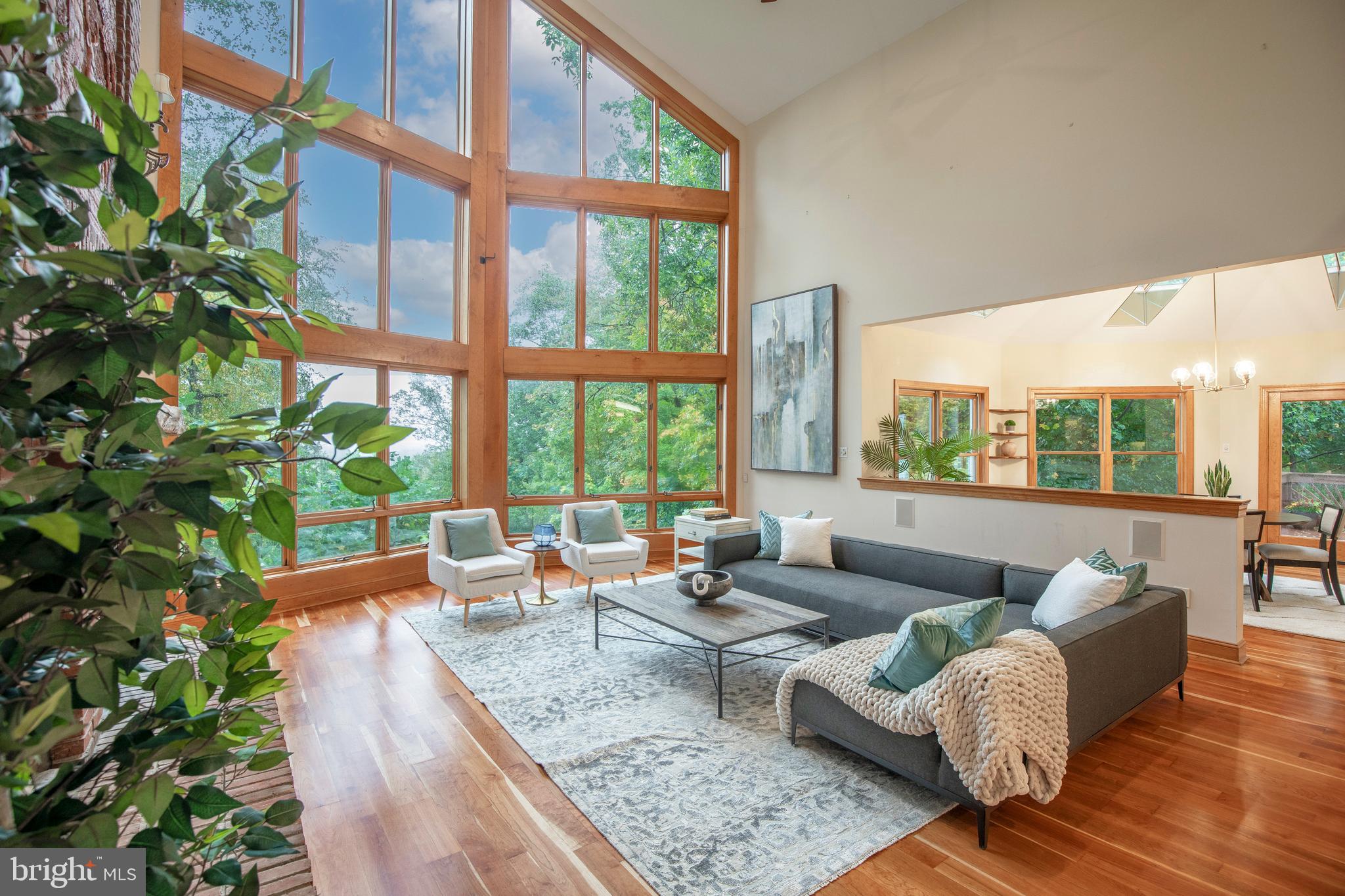 a living room with patio furniture and a potted plant