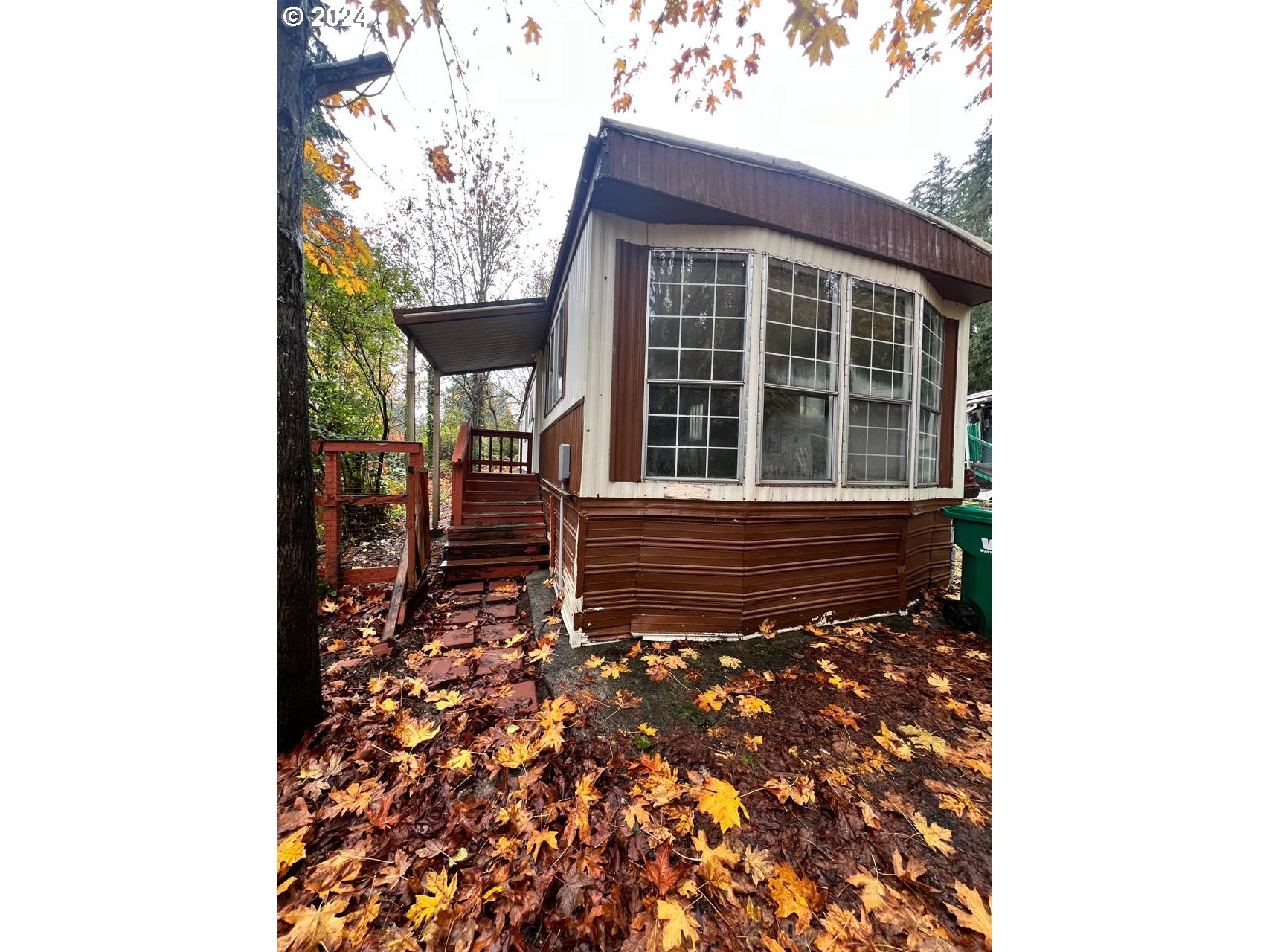 a view of a house with a small yard and floor to ceiling window