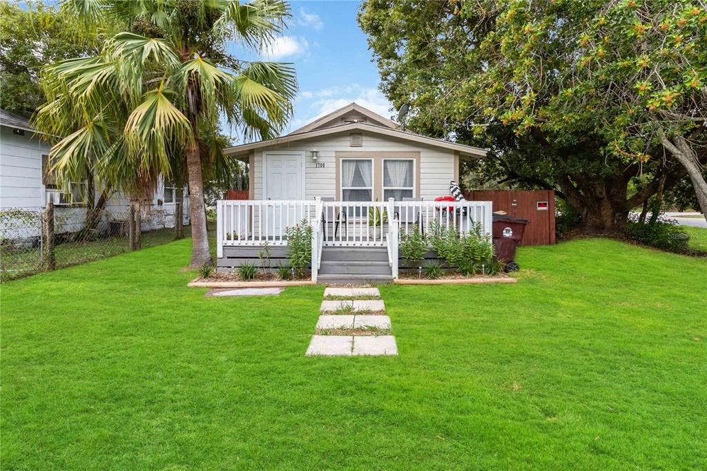 a front view of a house with a garden and yard