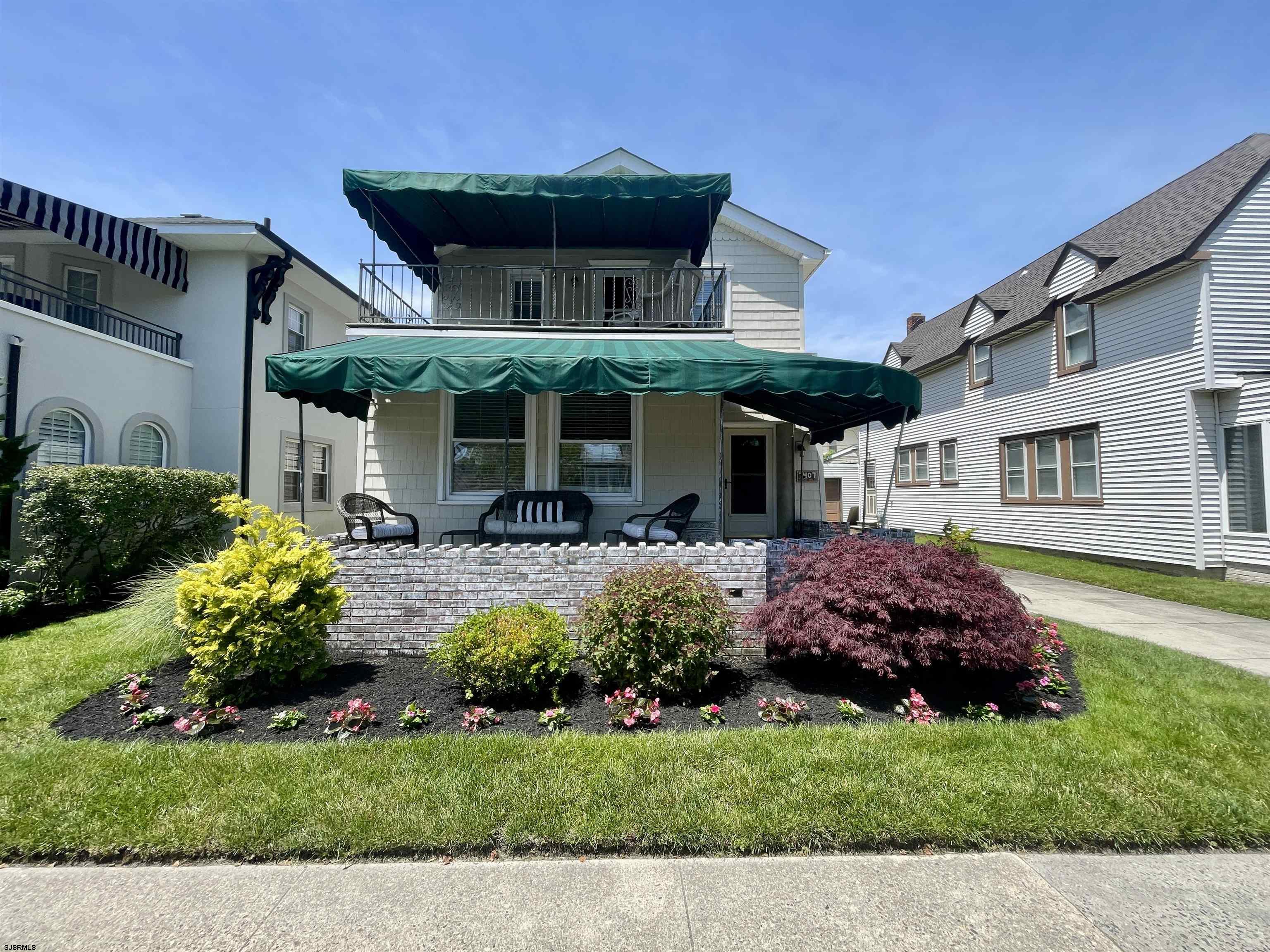 a front view of a house with a garden