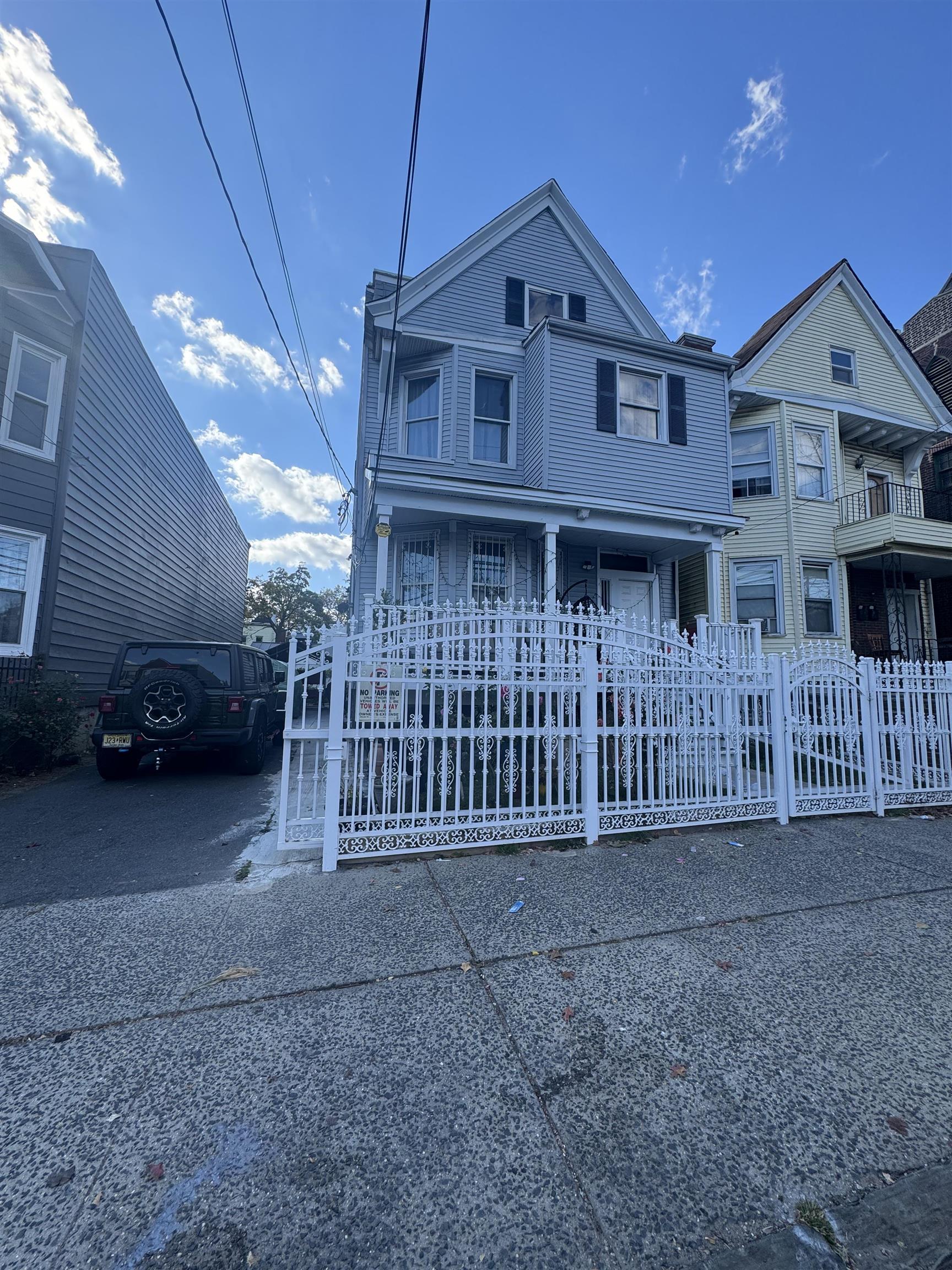 a view of a house with a deck and a yard