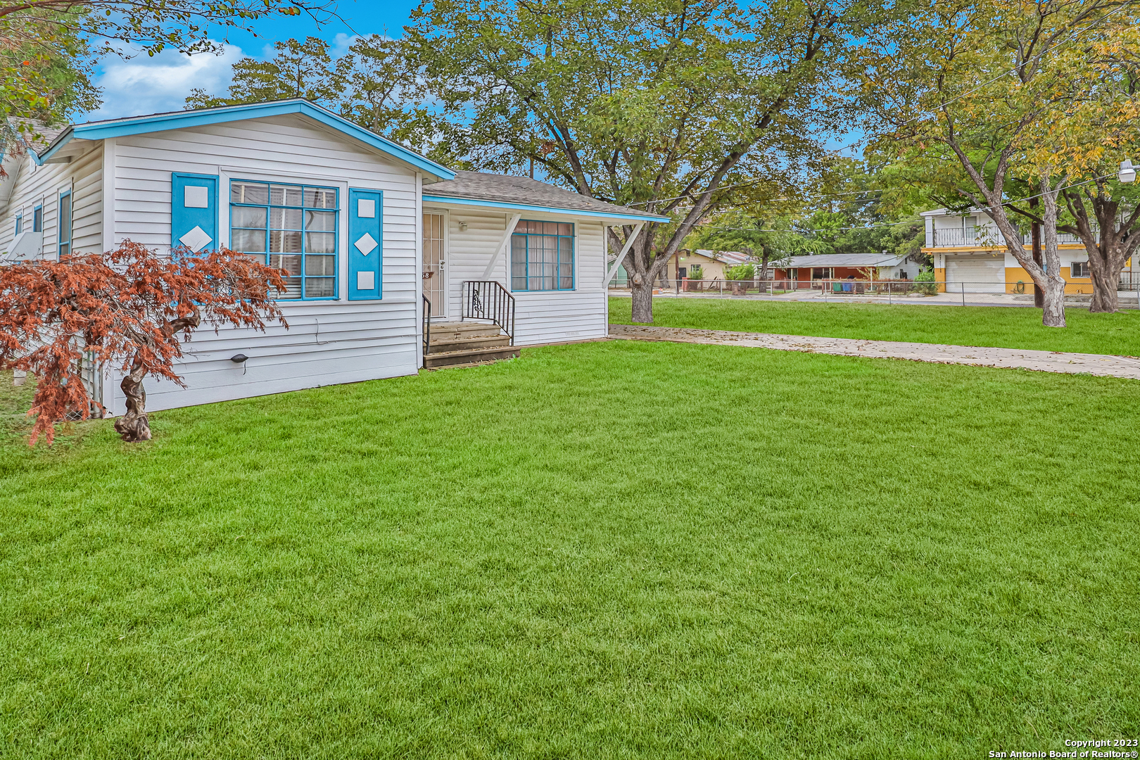 a front view of house with yard and green space