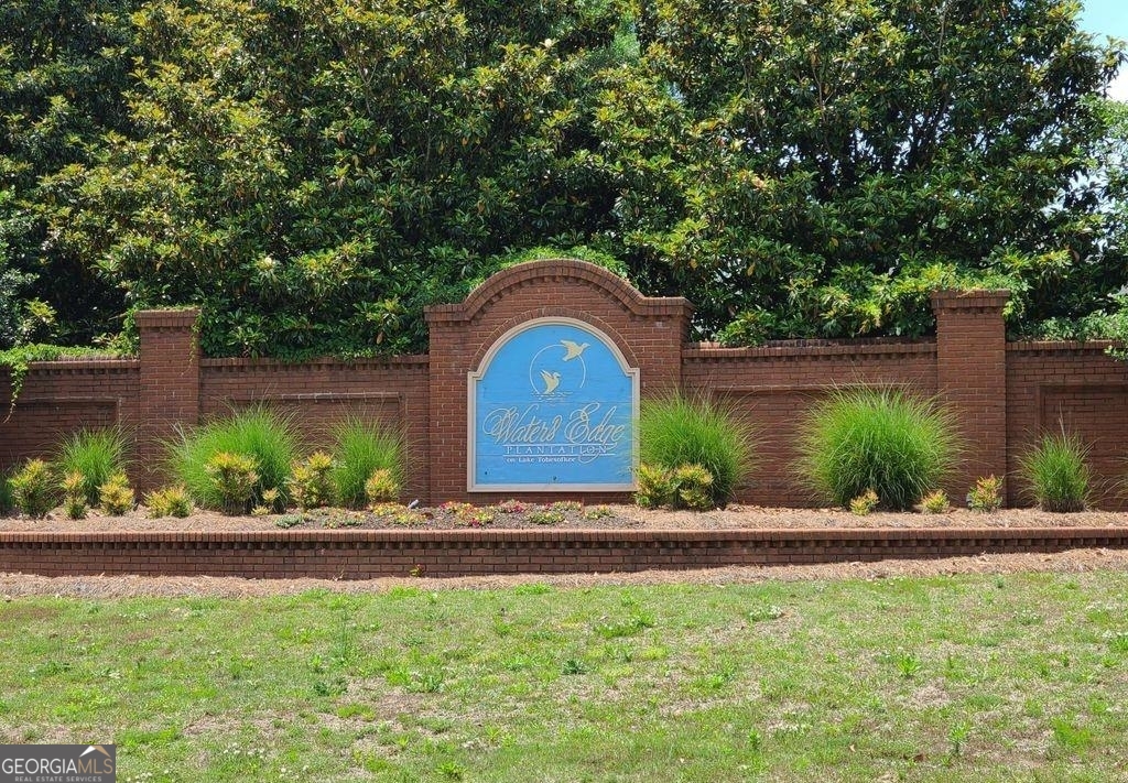 a front view of a house with a yard and a garden