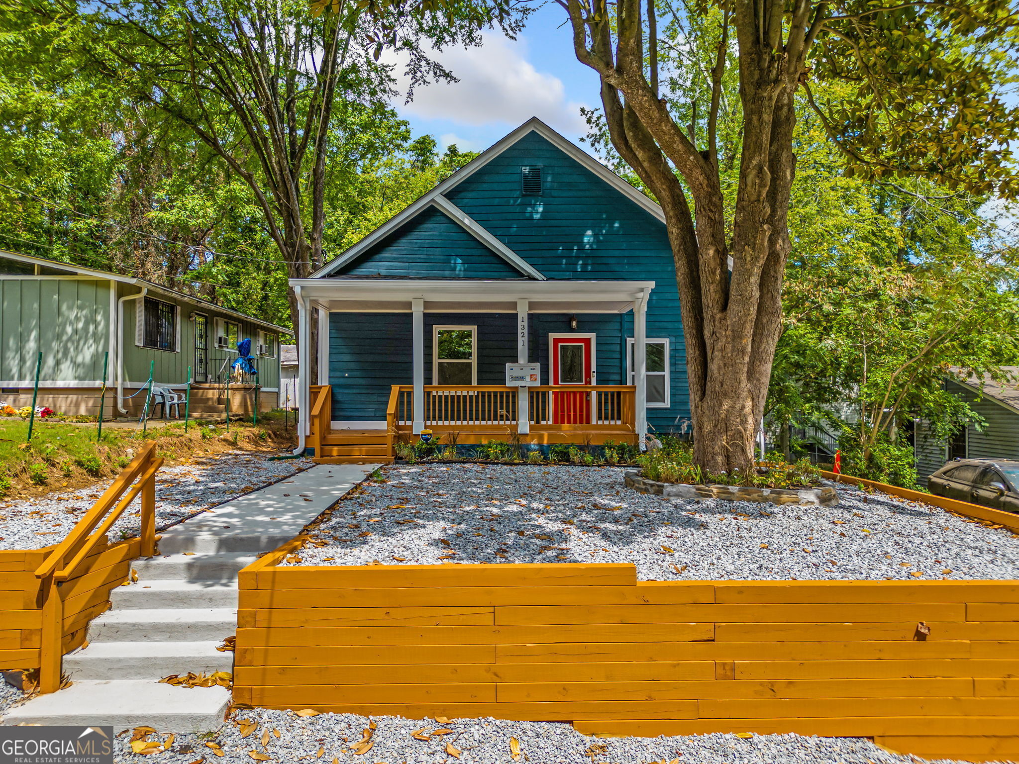 a view of a house with backyard and sitting area