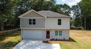 a front view of a house with a yard