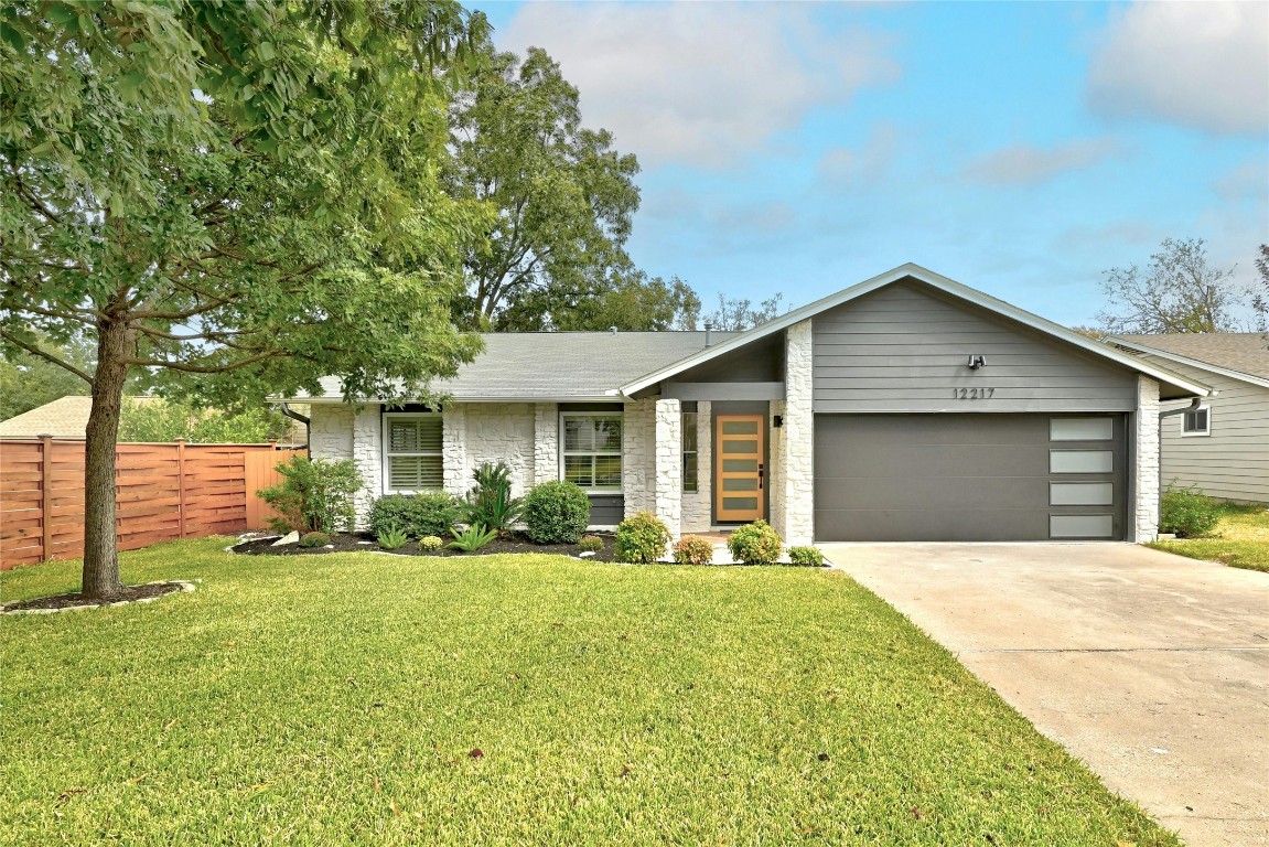 a front view of house with yard and green space