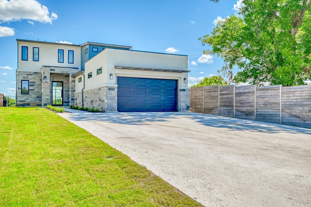 a view of a house with a yard and garage