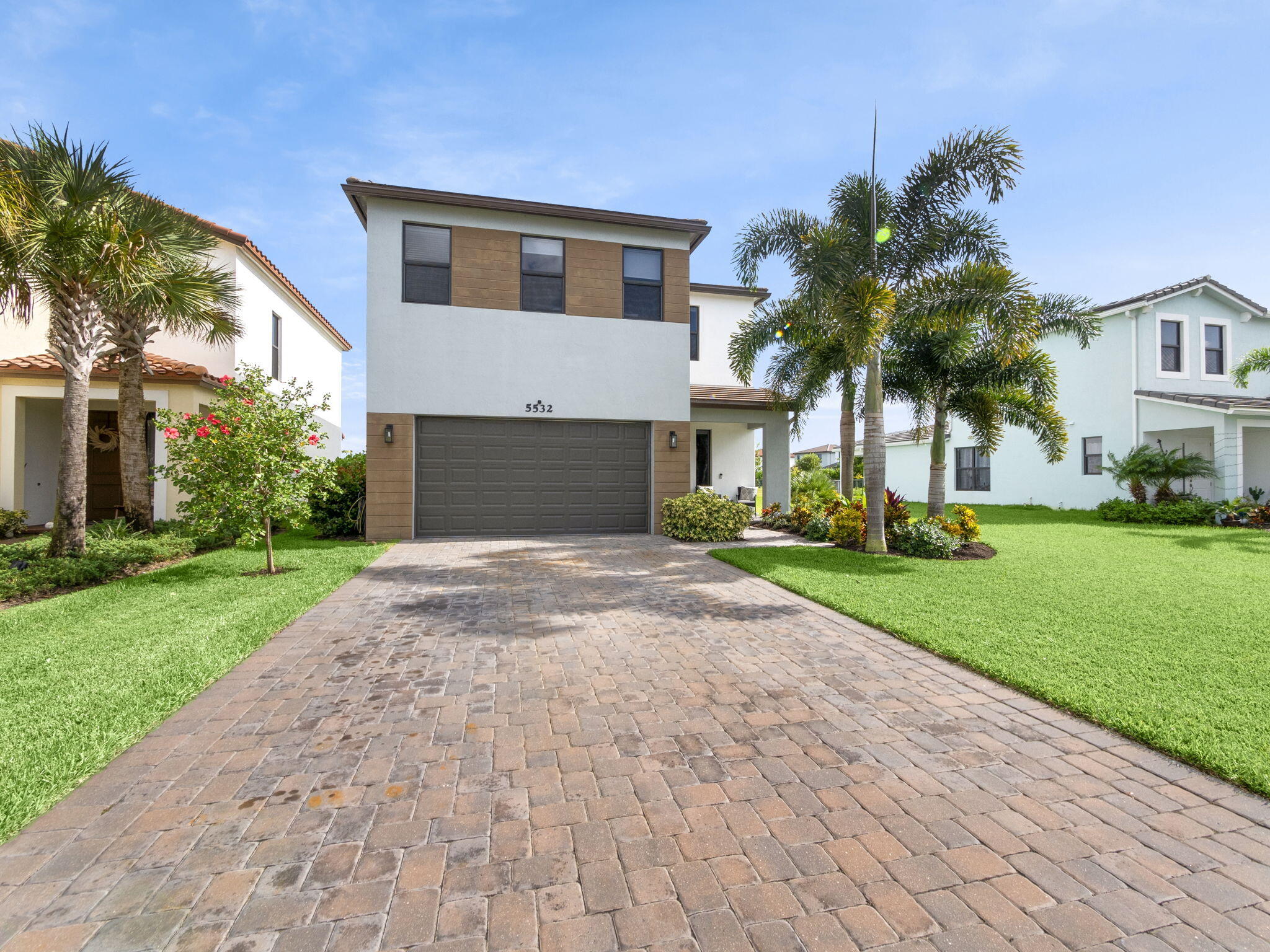 a front view of house with yard and green space