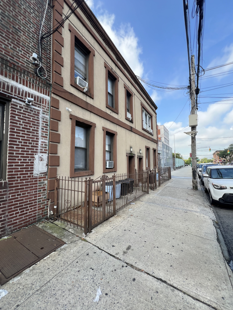 a view of a brick building with many windows