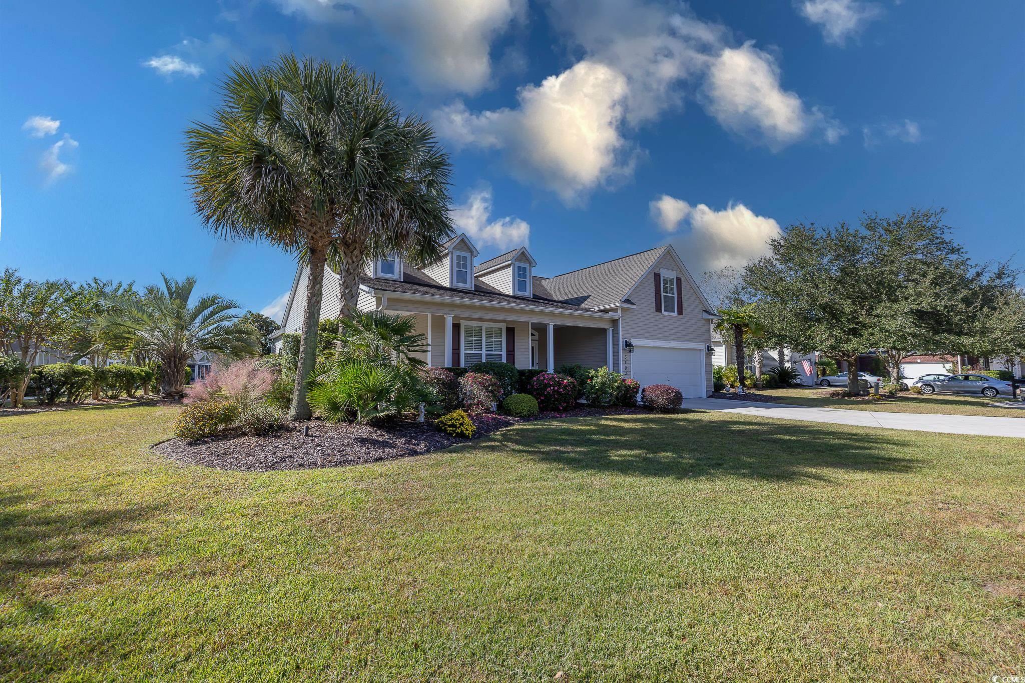 Cape cod-style house with a front lawn and a garag