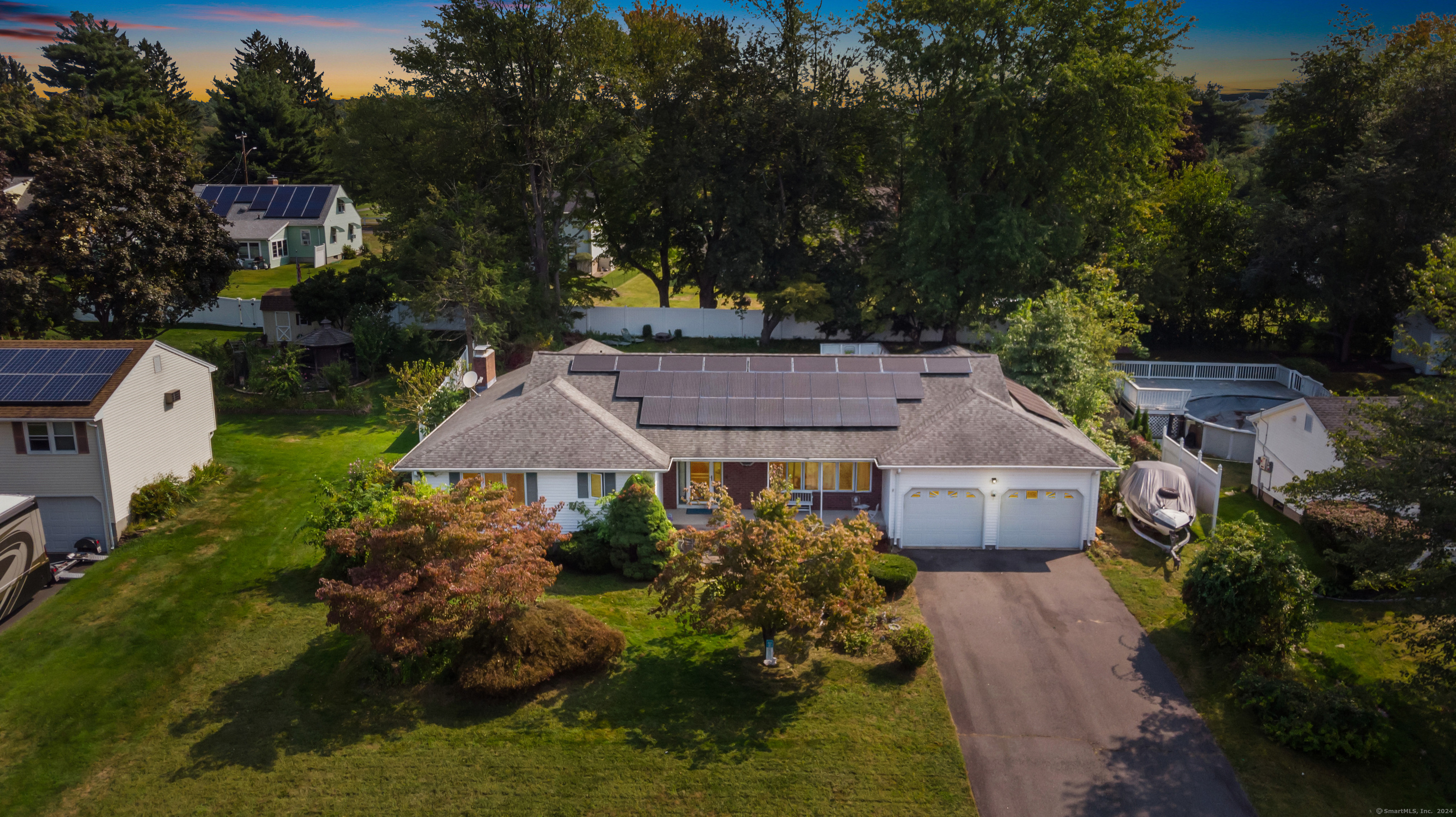 a aerial view of a house with a garden and lake view