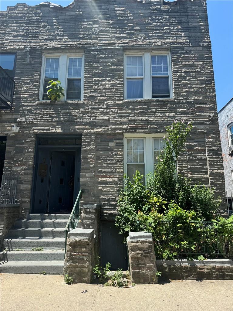 a front view of a house with stairs