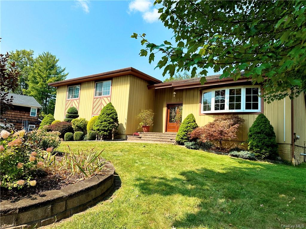 a front view of house with yard and green space