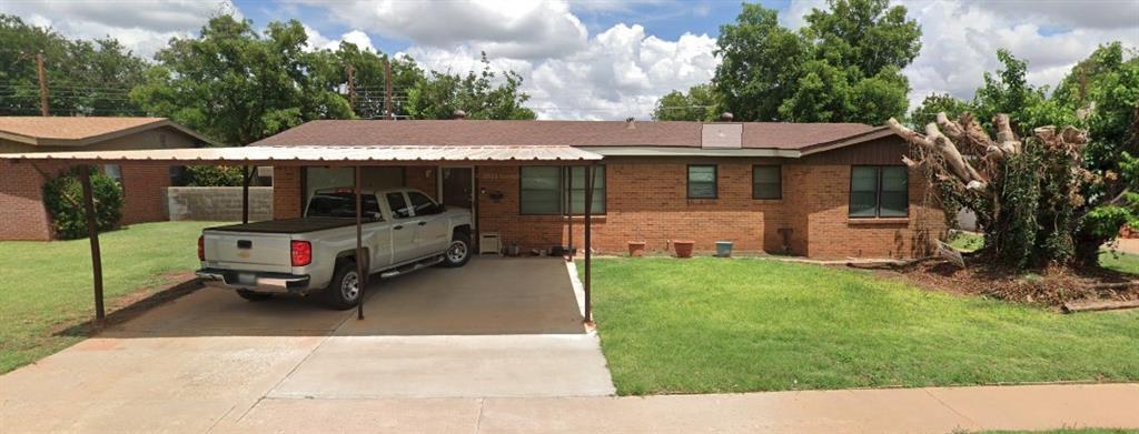 a view of a house with a backyard and patio