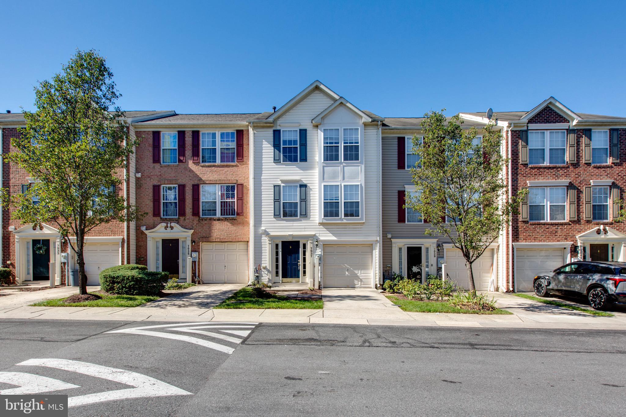 a front view of a residential apartment building with a yard