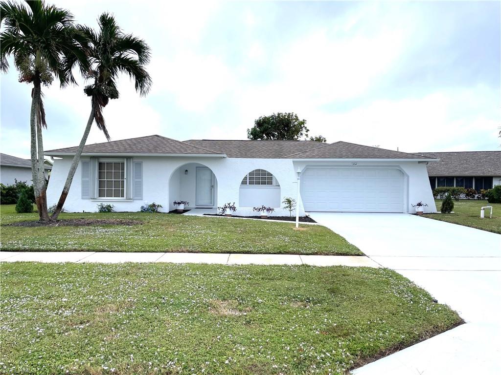 a front view of a house with a yard and garage