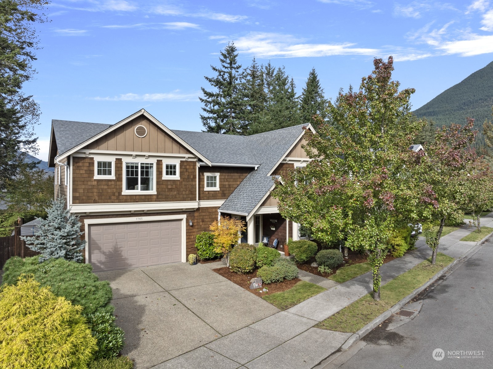 a front view of a house with a garden