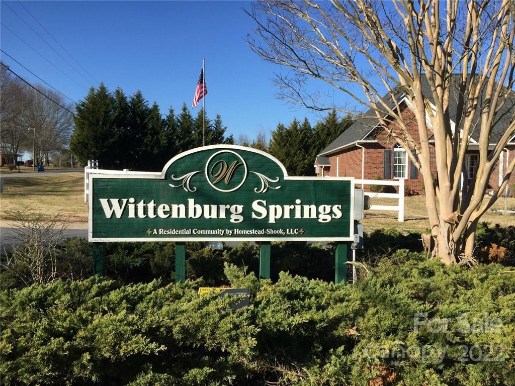 a sign broad in front of the red brick house