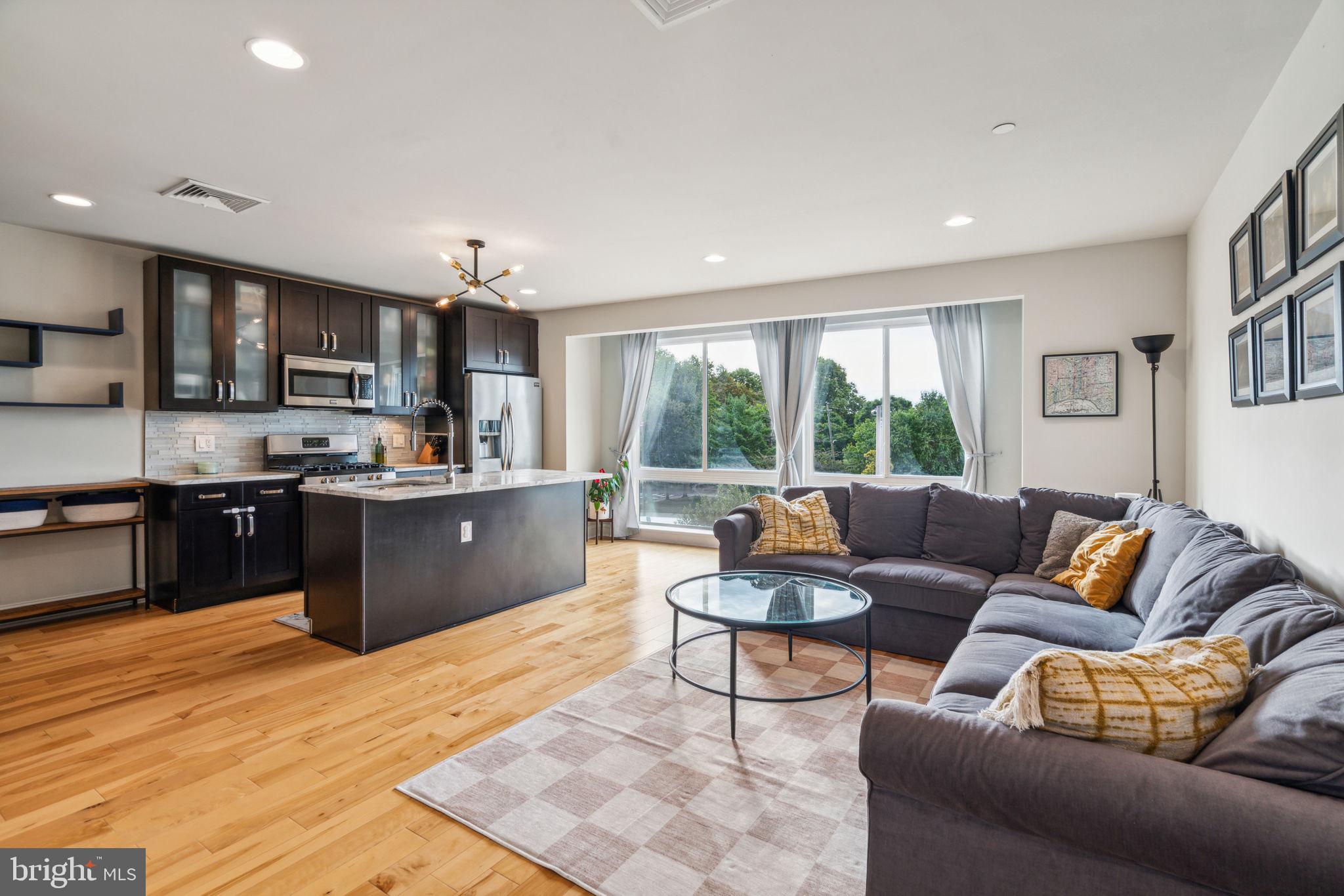 a living room with furniture and a kitchen