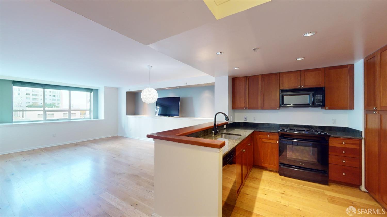 a kitchen with stainless steel appliances granite countertop a sink and a stove