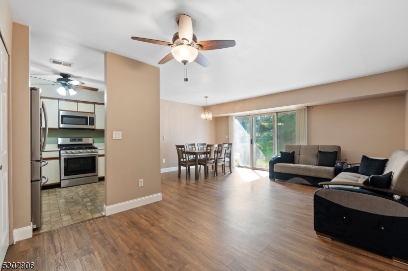 a living room with furniture and a view of kitchen