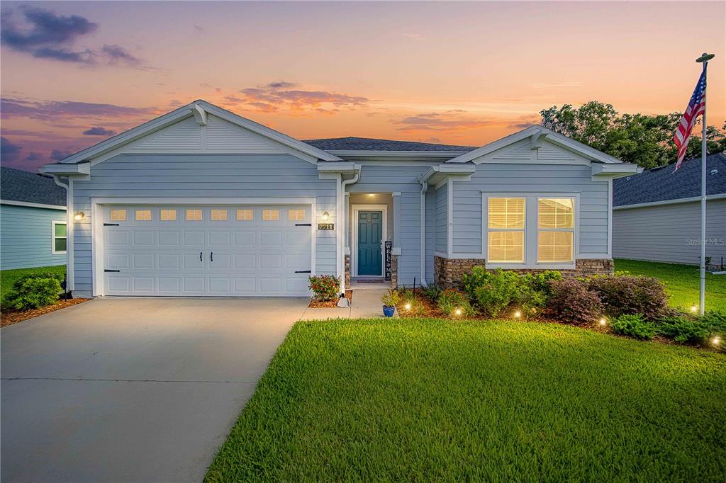 a front view of a house with a yard and garage