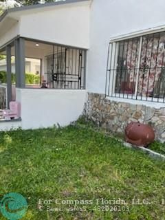 a view of an house with backyard space and balcony