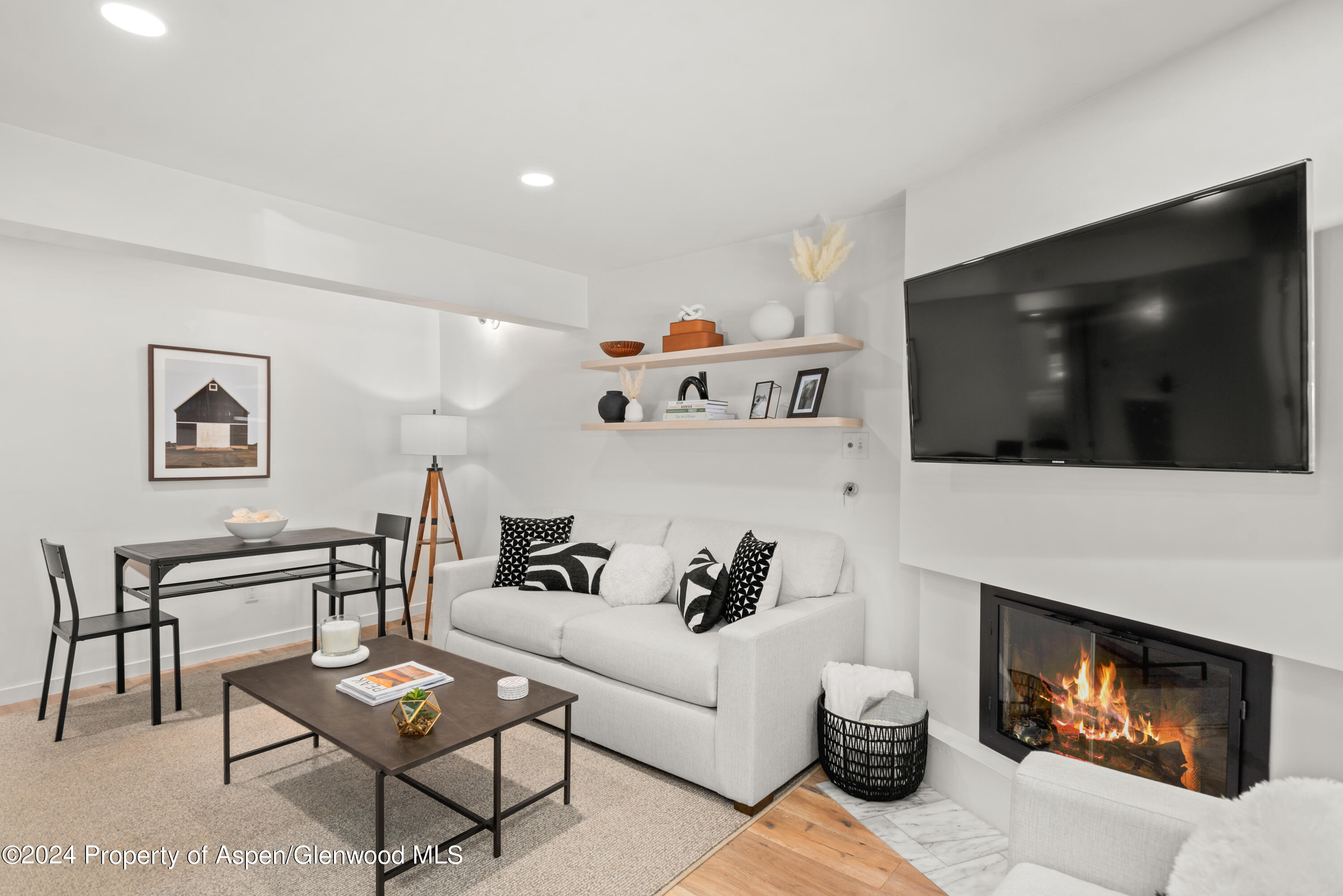 a living room with furniture a flat screen tv and a fireplace