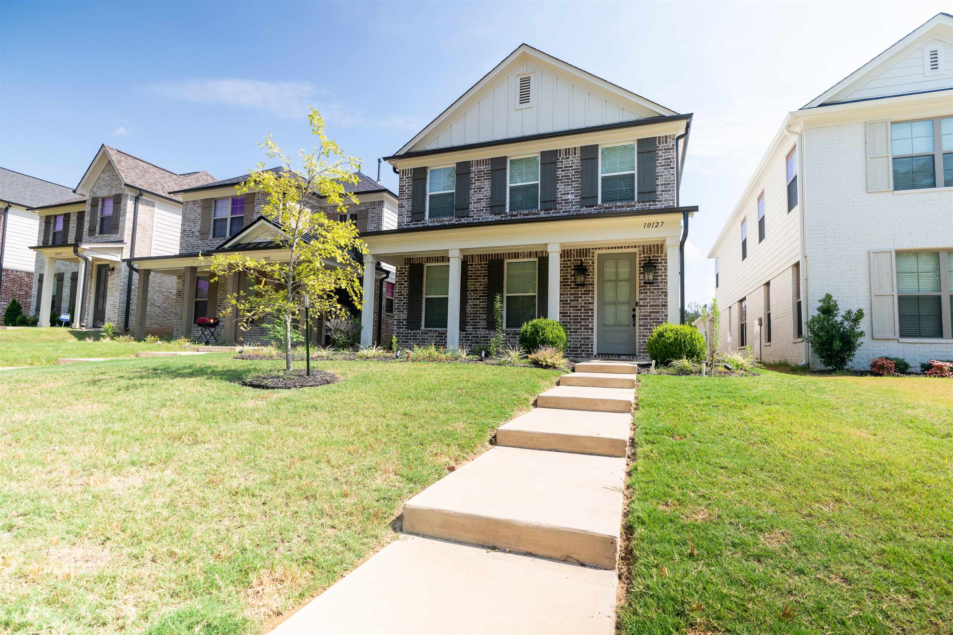 a front view of a house with a yard