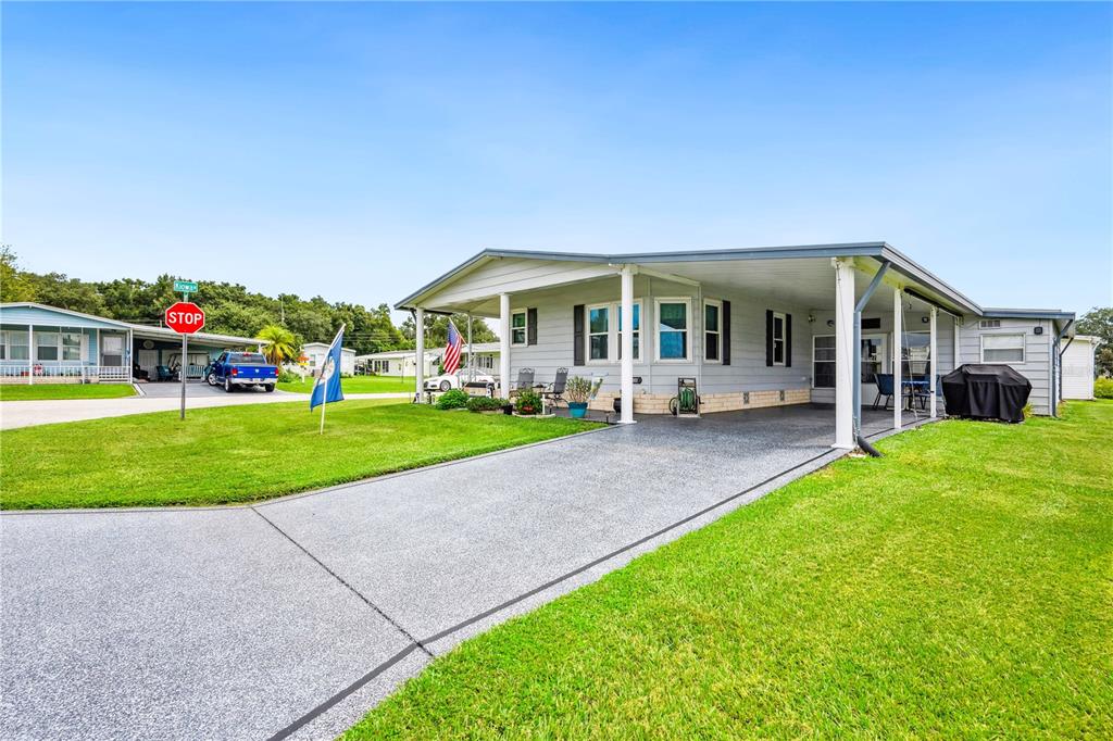 a view of a house with a yard porch and sitting area