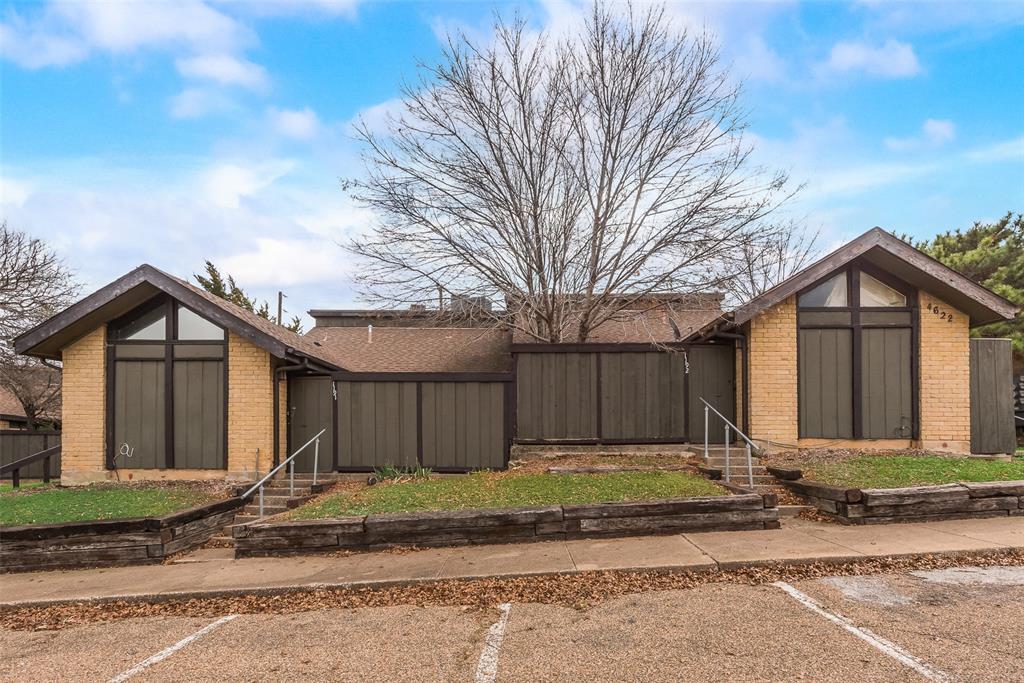 a view of a house with a yard next to a road