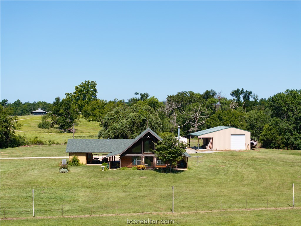 a view of a white house with a yard