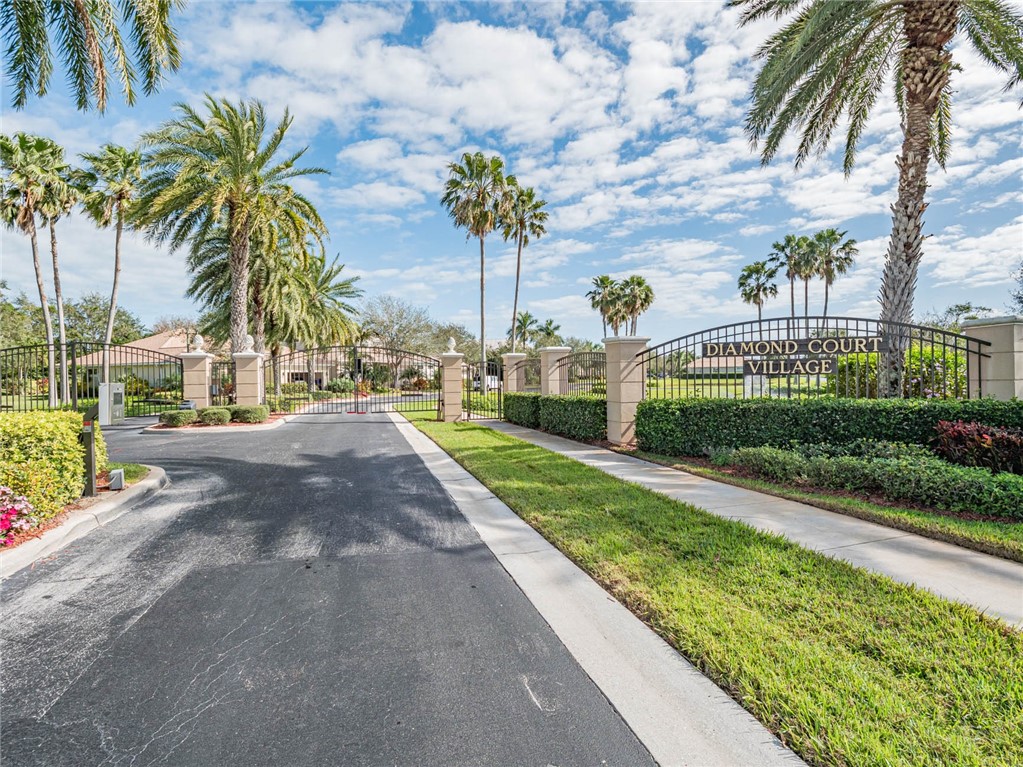 a view of a street with palm trees