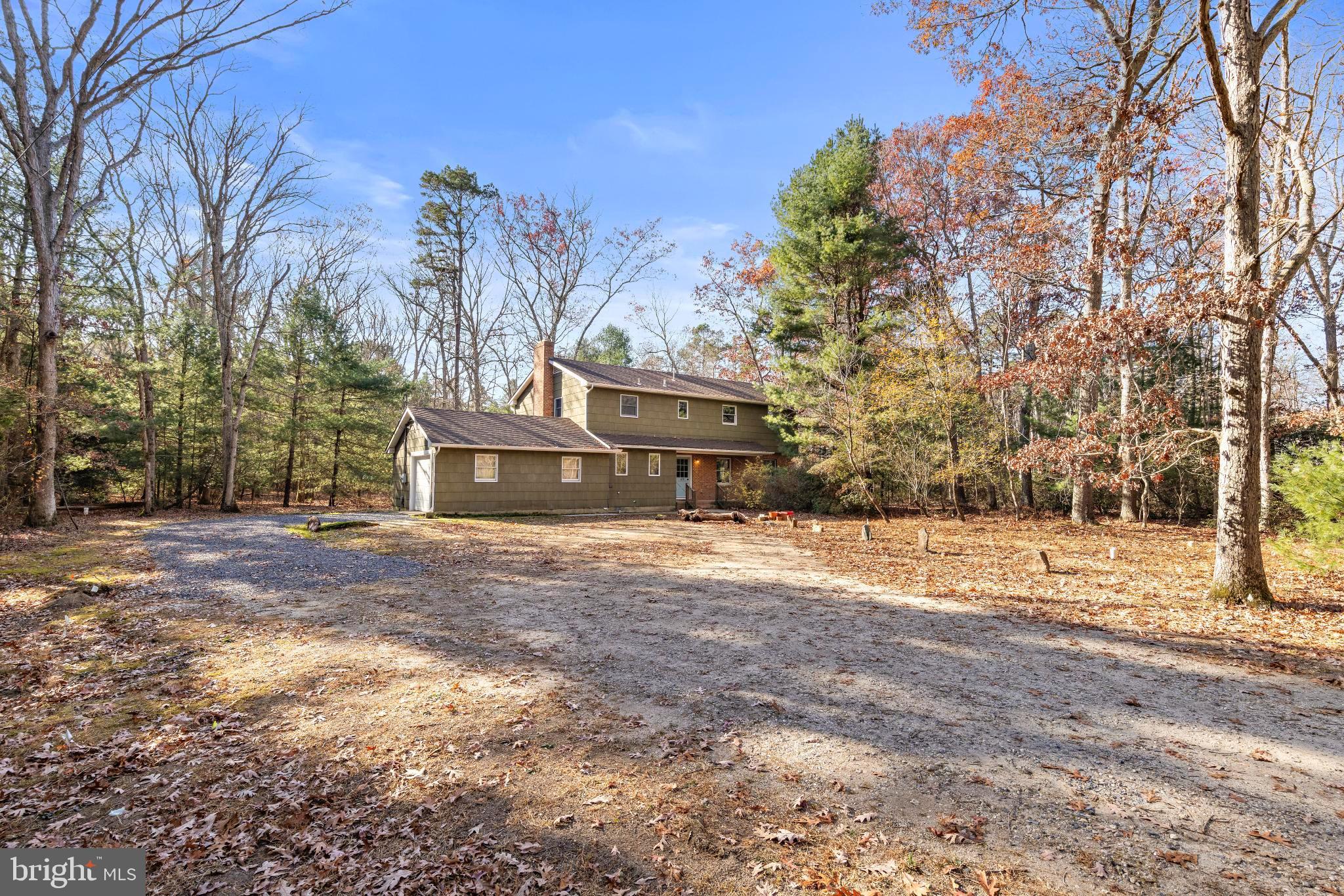 a view of a house with a yard covered with snow in front of house