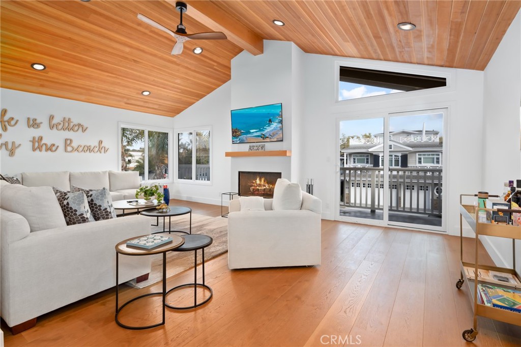 a living room with furniture a table and wooden floor