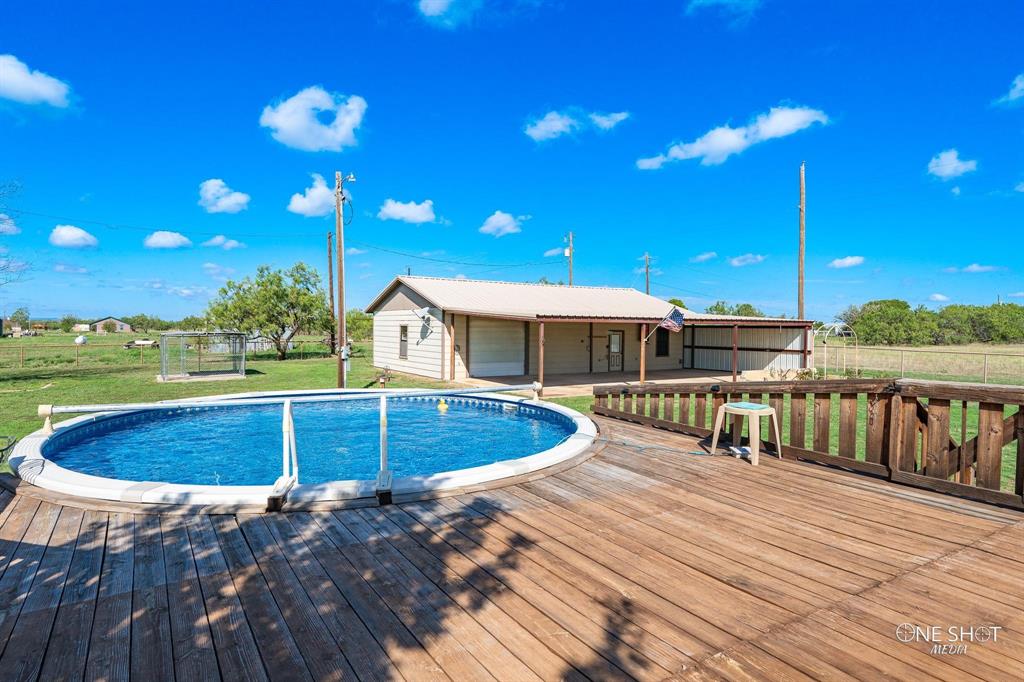 a view of a swimming pool with seating space