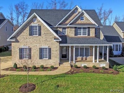 a front view of a house with a yard and porch